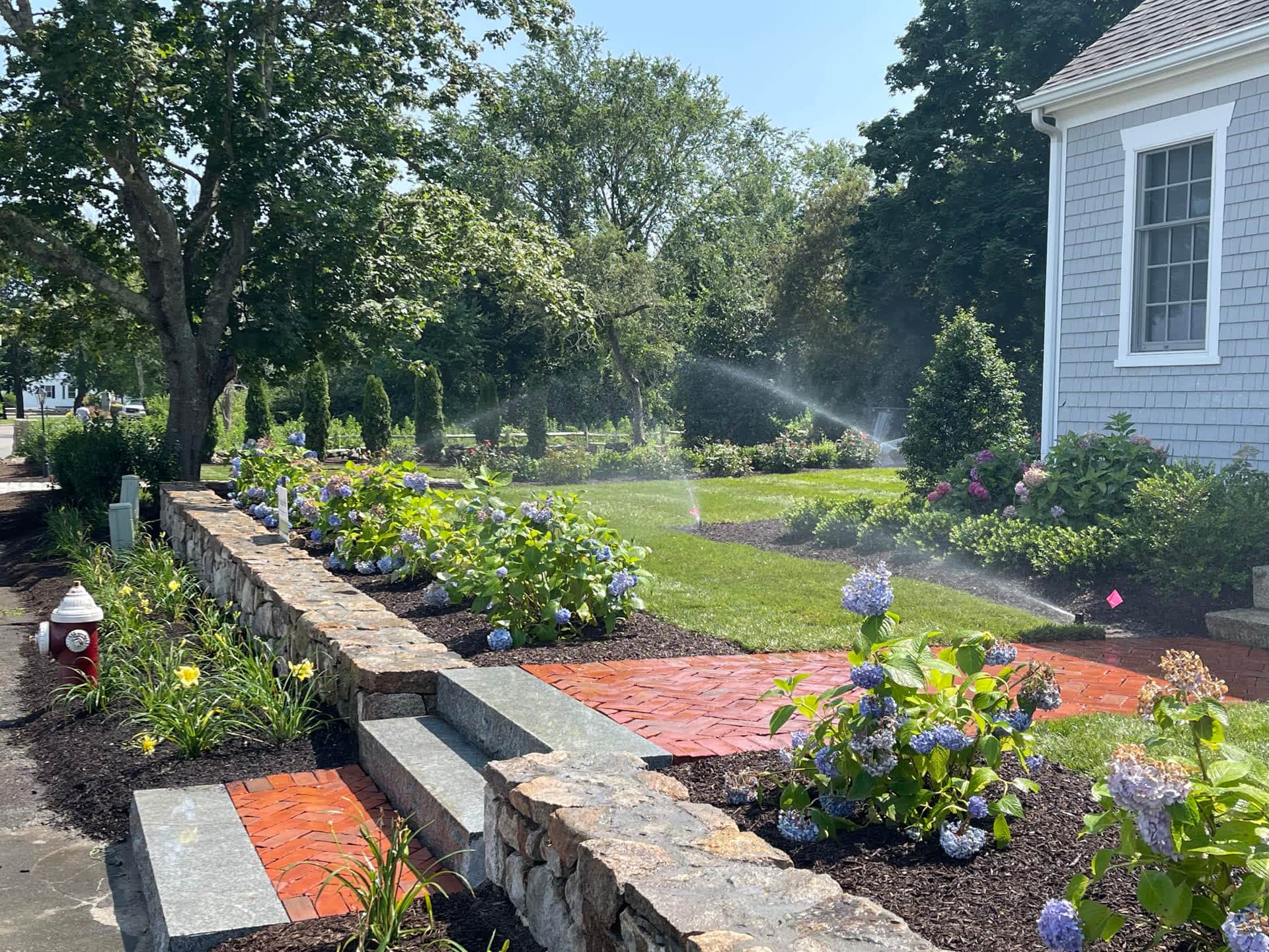 Brick walkway and garden beds by Michael William Associates